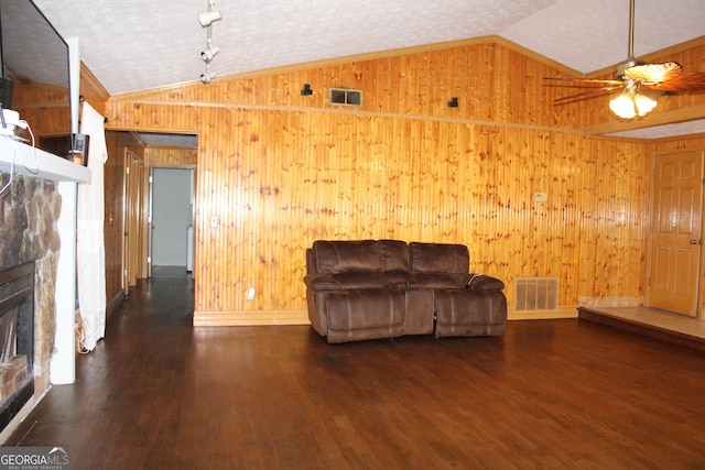 living room with visible vents, lofted ceiling, and wood finished floors