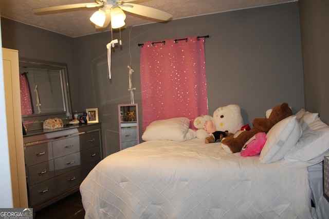 bedroom with a textured ceiling and ceiling fan