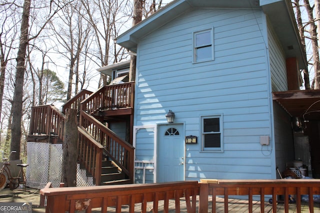 back of house with stairway and a wooden deck