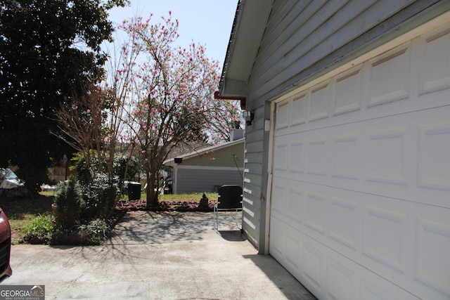 garage featuring concrete driveway