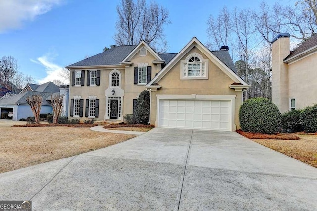 view of front of property featuring stucco siding, concrete driveway, and a chimney