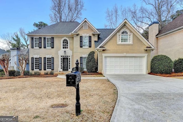 view of front of home featuring stucco siding, a garage, roof with shingles, and concrete driveway