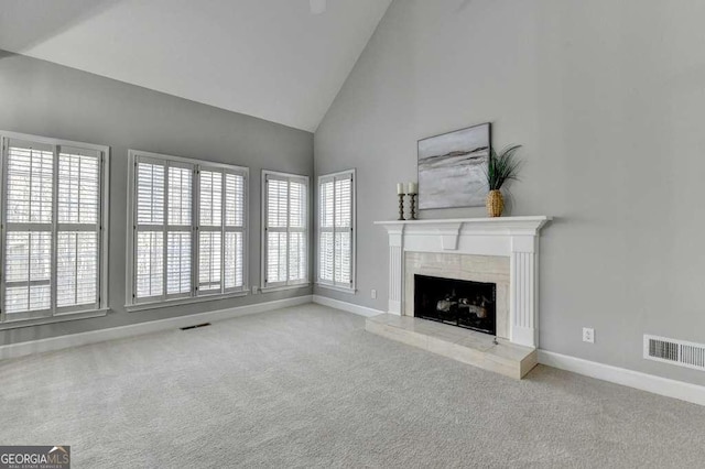 unfurnished living room with visible vents, carpet floors, and a tile fireplace