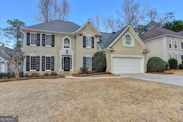 view of front of property with stucco siding, roof with shingles, concrete driveway, and an attached garage