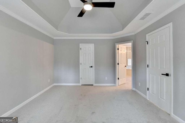 unfurnished bedroom featuring baseboards, lofted ceiling, ensuite bathroom, a raised ceiling, and carpet flooring