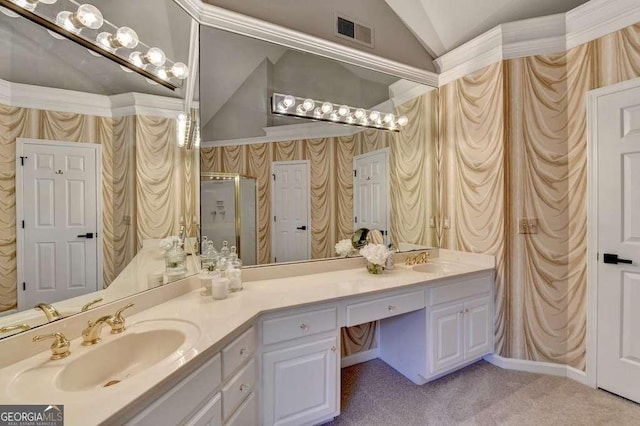 bathroom with lofted ceiling, double vanity, visible vents, and a sink