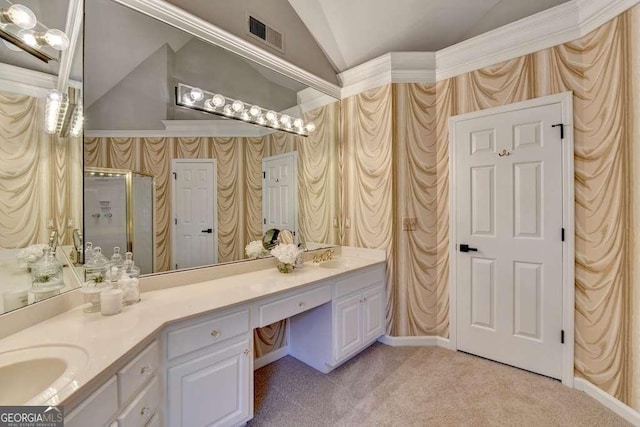 bathroom with double vanity, visible vents, wallpapered walls, and vaulted ceiling