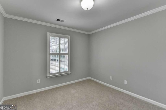 empty room with visible vents, baseboards, crown molding, and carpet