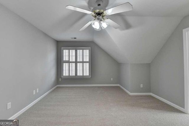 bonus room featuring a ceiling fan, visible vents, baseboards, vaulted ceiling, and carpet flooring