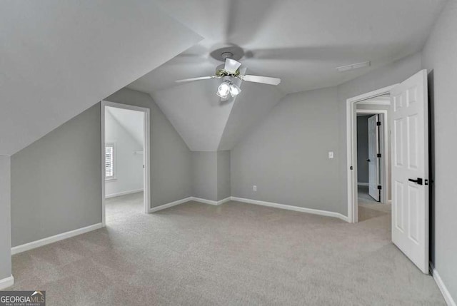 bonus room with baseboards, lofted ceiling, a ceiling fan, and carpet floors