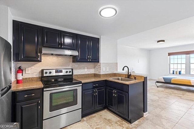 kitchen with tasteful backsplash, under cabinet range hood, appliances with stainless steel finishes, a peninsula, and a sink