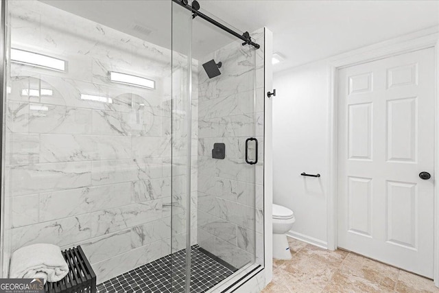 bathroom with baseboards, toilet, and a shower stall