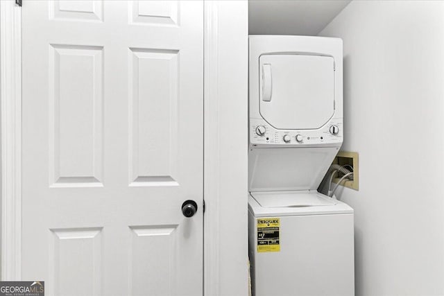 washroom featuring laundry area and stacked washer and dryer