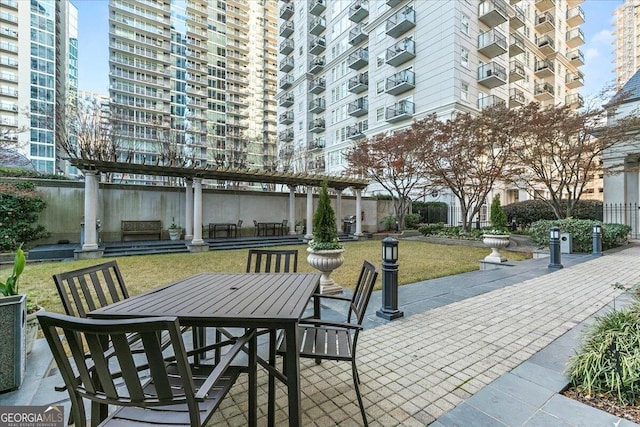 view of patio with outdoor dining space and a pergola