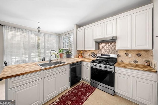 kitchen featuring under cabinet range hood, stainless steel gas stove, dishwasher, a sink, and wood counters