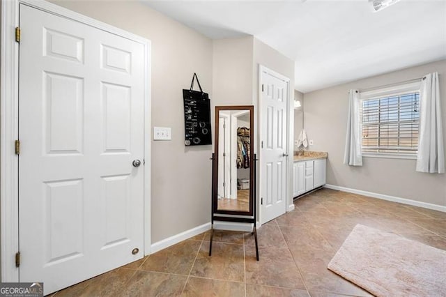 interior space featuring tile patterned floors and baseboards