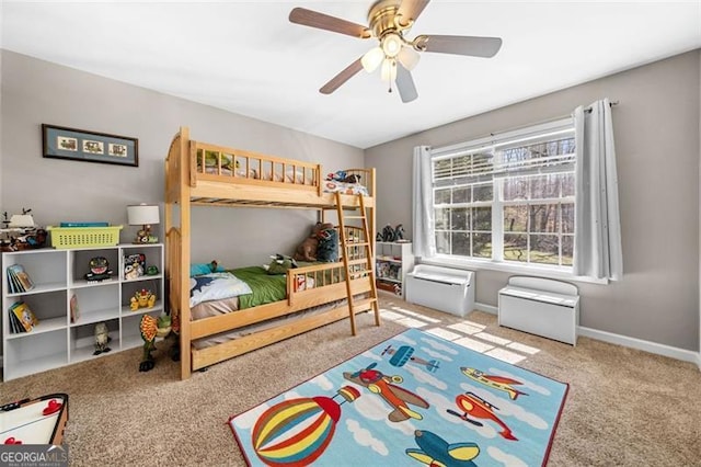 carpeted bedroom with baseboards and ceiling fan