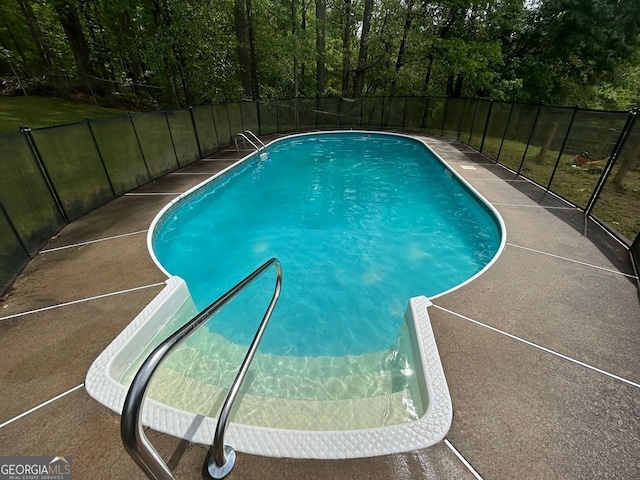 view of swimming pool featuring fence and a fenced in pool