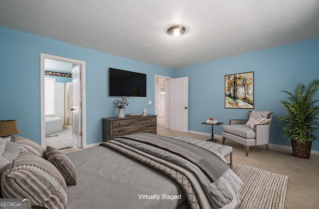 bedroom featuring light carpet, connected bathroom, and baseboards