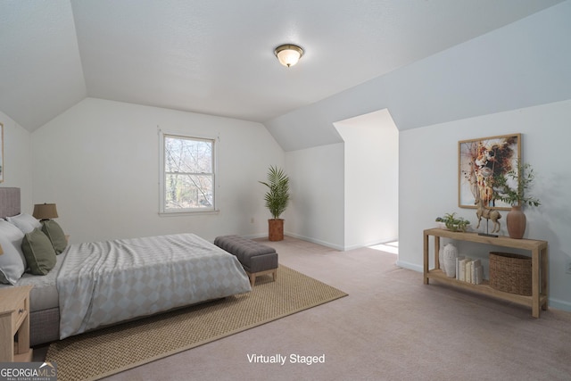 carpeted bedroom with baseboards and vaulted ceiling