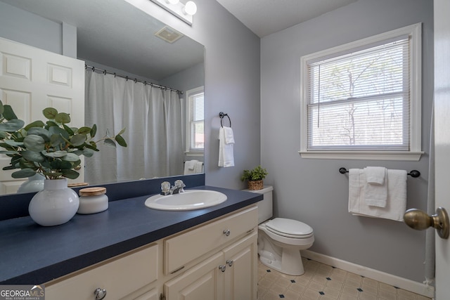 bathroom with visible vents, baseboards, toilet, a shower with shower curtain, and vanity