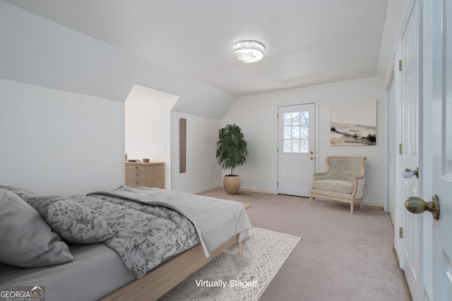 bedroom with carpet flooring, baseboards, and lofted ceiling