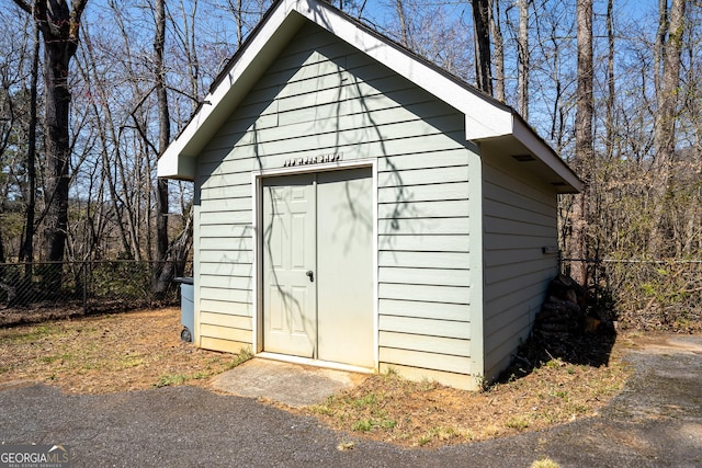 view of shed featuring fence