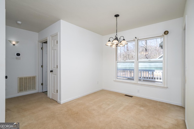 unfurnished dining area featuring a chandelier, visible vents, and light colored carpet