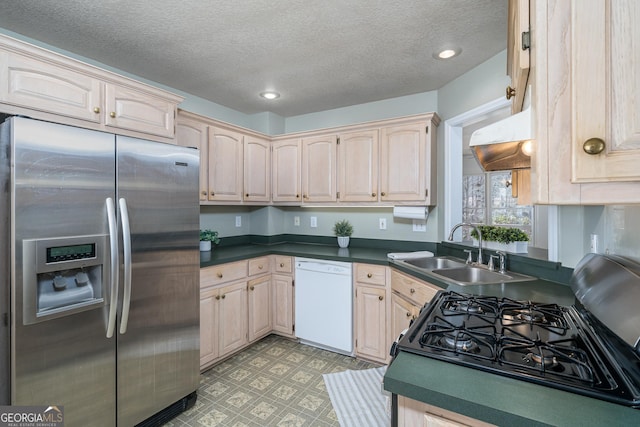 kitchen featuring light floors, white dishwasher, a sink, stainless steel refrigerator with ice dispenser, and black range with gas stovetop