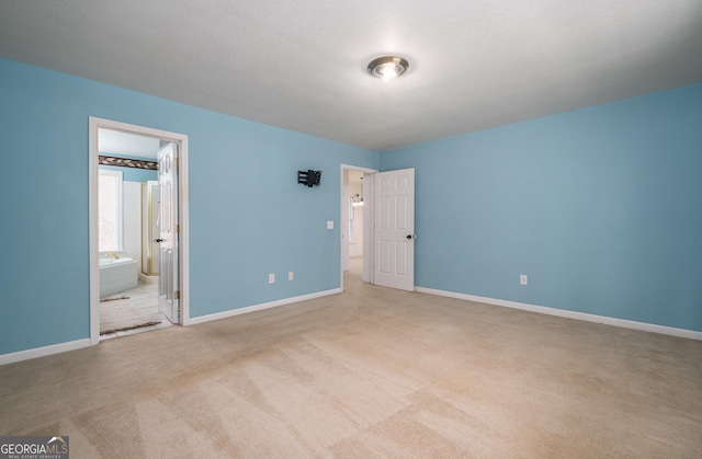 unfurnished bedroom featuring baseboards and carpet floors