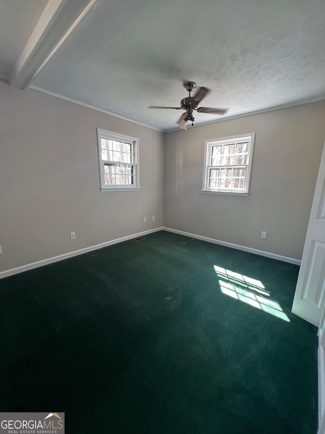 unfurnished bedroom with baseboards, beam ceiling, a textured ceiling, a ceiling fan, and dark colored carpet