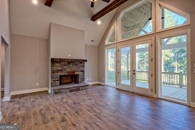 unfurnished living room with hardwood / wood-style flooring, beamed ceiling, and a healthy amount of sunlight