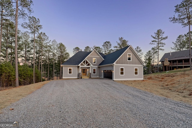 view of front facade with a garage, board and batten siding, and driveway