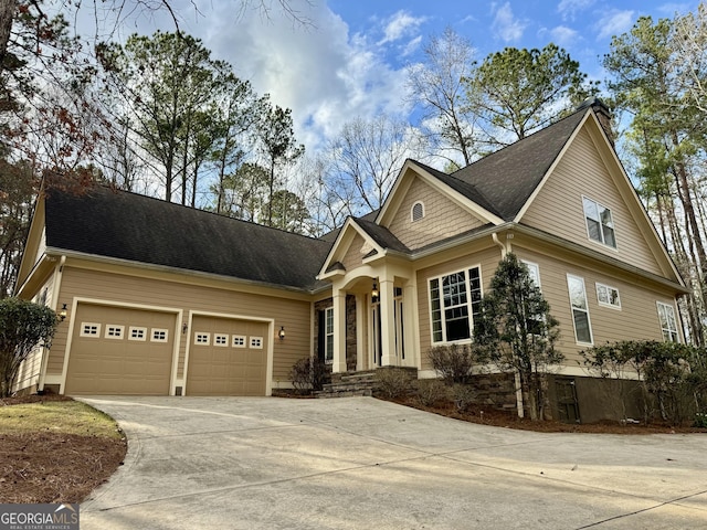 view of front of house featuring concrete driveway and a garage