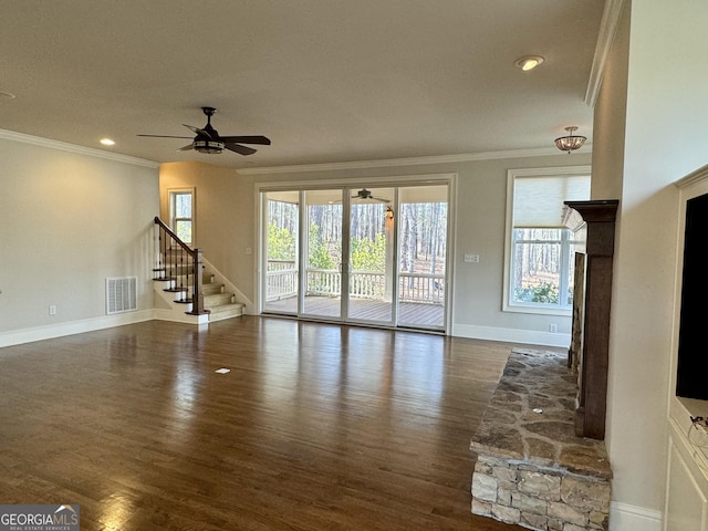 unfurnished living room featuring visible vents, crown molding, stairs, ceiling fan, and dark wood-type flooring
