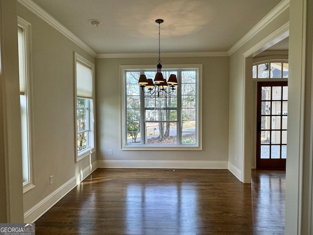 unfurnished dining area with dark wood-style flooring, ornamental molding, and a chandelier