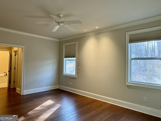 unfurnished room with baseboards, crown molding, and dark wood-type flooring