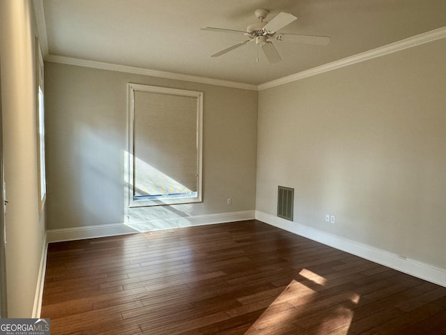 unfurnished room featuring crown molding, baseboards, visible vents, a ceiling fan, and wood finished floors
