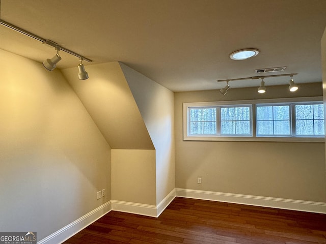 bonus room with visible vents, baseboards, lofted ceiling, and wood finished floors