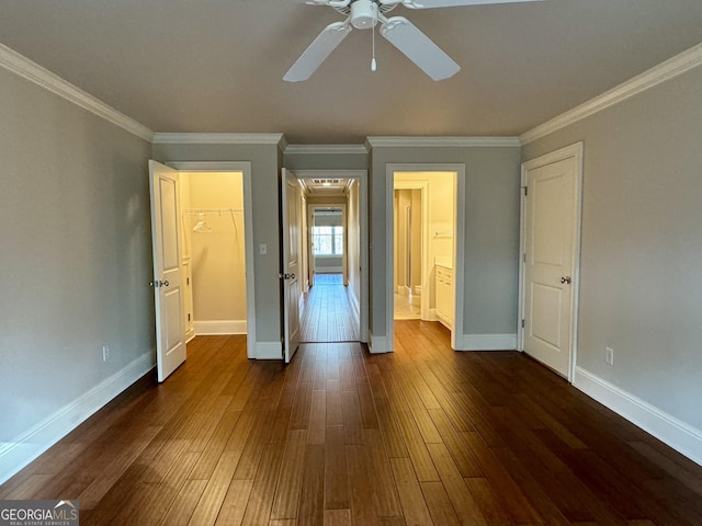 unfurnished bedroom with baseboards, crown molding, a ceiling fan, and dark wood-style flooring