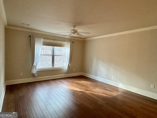 spare room with dark wood-style floors, baseboards, visible vents, ceiling fan, and ornamental molding