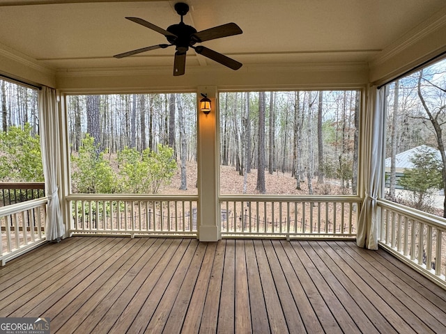 unfurnished sunroom featuring a ceiling fan