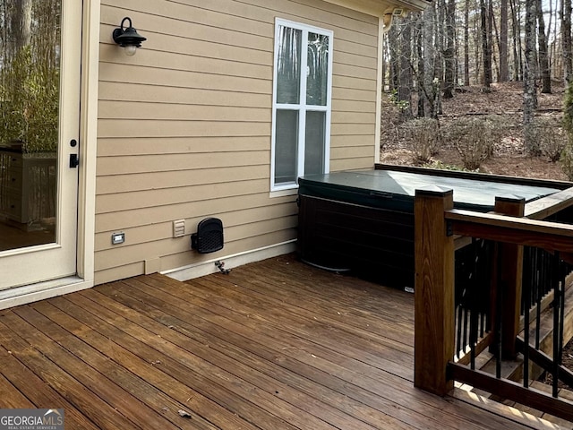 wooden deck featuring a hot tub