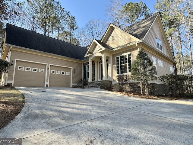view of front of house featuring concrete driveway and a garage