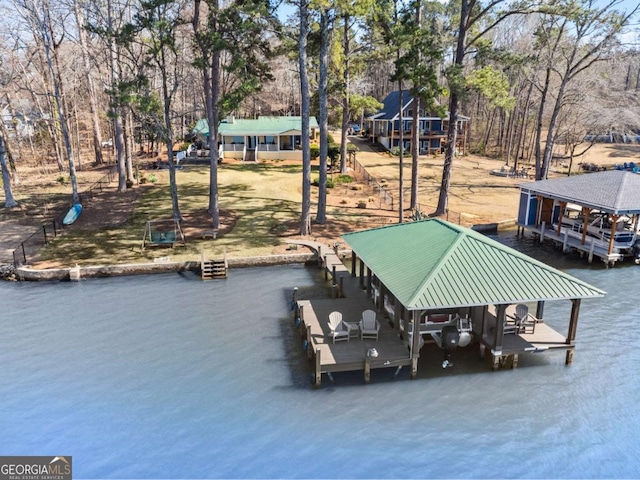 dock area featuring boat lift and a water view