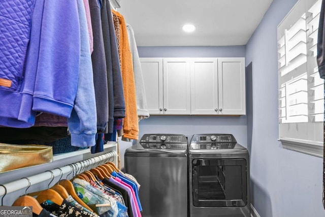 clothes washing area featuring recessed lighting, baseboards, cabinet space, and washer and clothes dryer