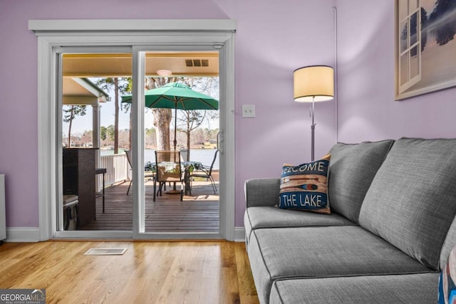 interior space featuring visible vents, baseboards, and wood finished floors