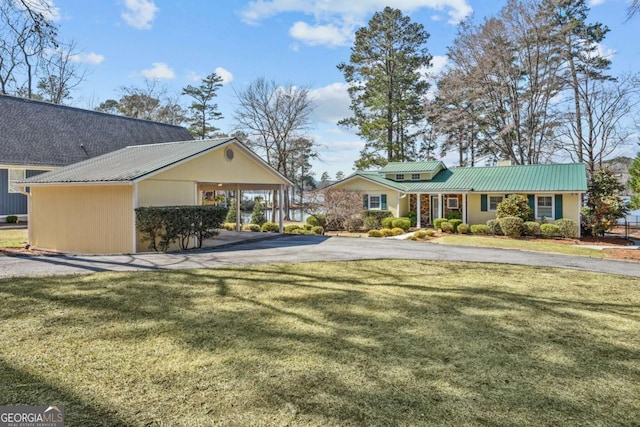 exterior space featuring aphalt driveway and an attached carport