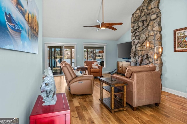 living room with wood finished floors, baseboards, and ceiling fan