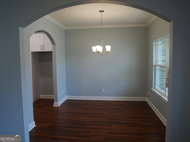 interior space featuring ornamental molding, dark wood-style floors, arched walkways, baseboards, and a chandelier